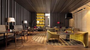 A modern lounge area with a checkered floor, wooden ceiling, and striped walls. - Wanda Yue,Huaian Hongze Lake (Huai'an)