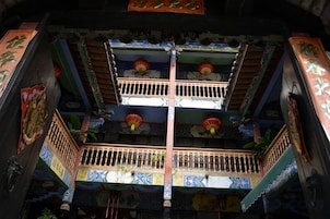 A traditional multi-level building with balconies and decorative elements.