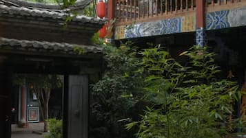 A traditional Chinese architectural structure with a tiled roof and a wooden balcony.