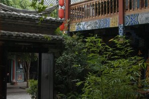 A traditional Chinese architectural structure with a tiled roof and a wooden balcony.
