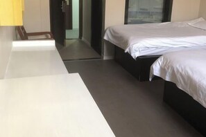 A modern hotel room with a bed, a desk, and a chair. - Fengxing Hostel (Shanghai)