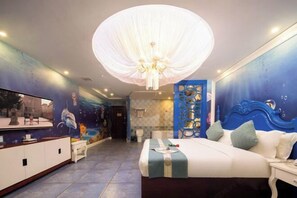 A hotel room with a large bed, a television, a chandelier, and a mural on the wall. - nanyuan e home hotel （liu an Railway Station Hotel ） ） (Lu'an)