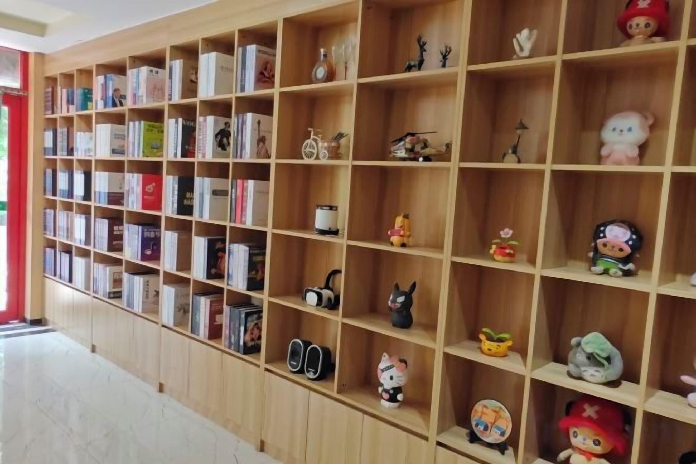 A room with a bookshelf filled with books and various decorative items.