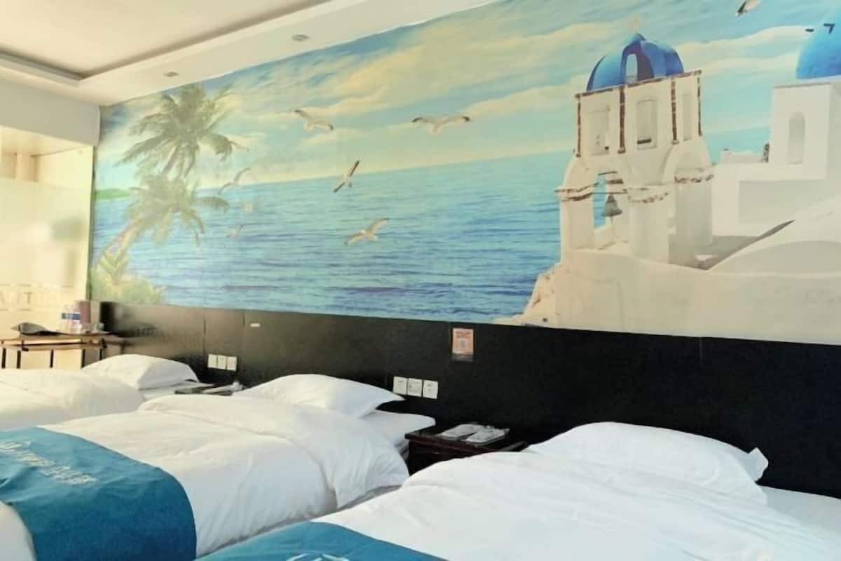 A hotel room with two beds, a mural of a coastal scene, and a view of the sea.