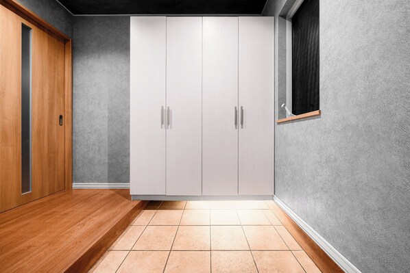 A room with a wardrobe, a wooden floor, and a textured wall. - THE GRACIOUS (Sapporo)