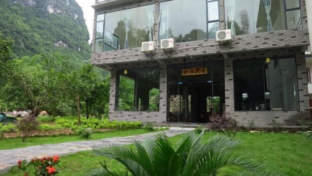 A two-story building with large windows and a brick facade. - Yellow Cloth Reflection Inn (Yangshuo)