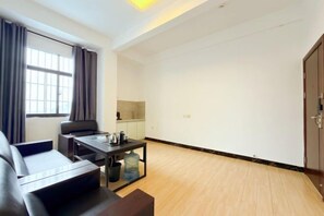 A modern living room with a sofa, a coffee table, and a dining table.