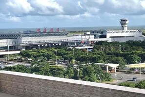 An airport terminal with a control tower, multiple gates, and a parking area. - Mossflower Hotel (Zhuhai Jinwan Airport) (Zhuhai)