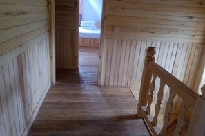 A wooden interior hallway with a wooden railing on the right. - Ergune Enhe E Qing Moutain Villa (Ergun)