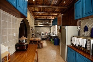 A kitchen with wooden cabinets, a tiled backsplash, and a stainless steel refrigerator.
