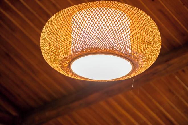 A spherical, woven light fixture with a central white light source.
