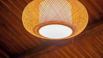 A spherical, woven light fixture with a central white light source.