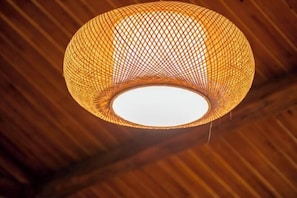 A spherical, woven light fixture with a central white light source. - Huayutang Renwen Inn (Luoping)