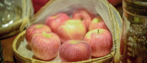 A basket of apples on a wooden surface.