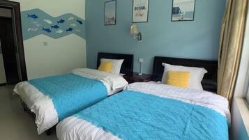 A hotel room with two beds, a wall mural, and a window with curtains.