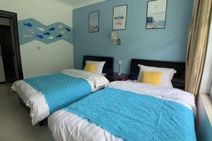 A hotel room with two beds, a wall mural, and a window with curtains. - Home of Little Bee Guesthouse (Hezhou)
