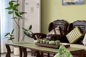 Enjoy a traditional setting with a dining table, potted plant, and comfortable sofa.
