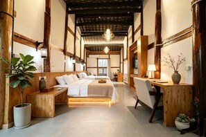A traditional Japanese-style bedroom with a bed, bedside tables, a desk, and a chair. - Qinjia Courtyard (Langzhong)