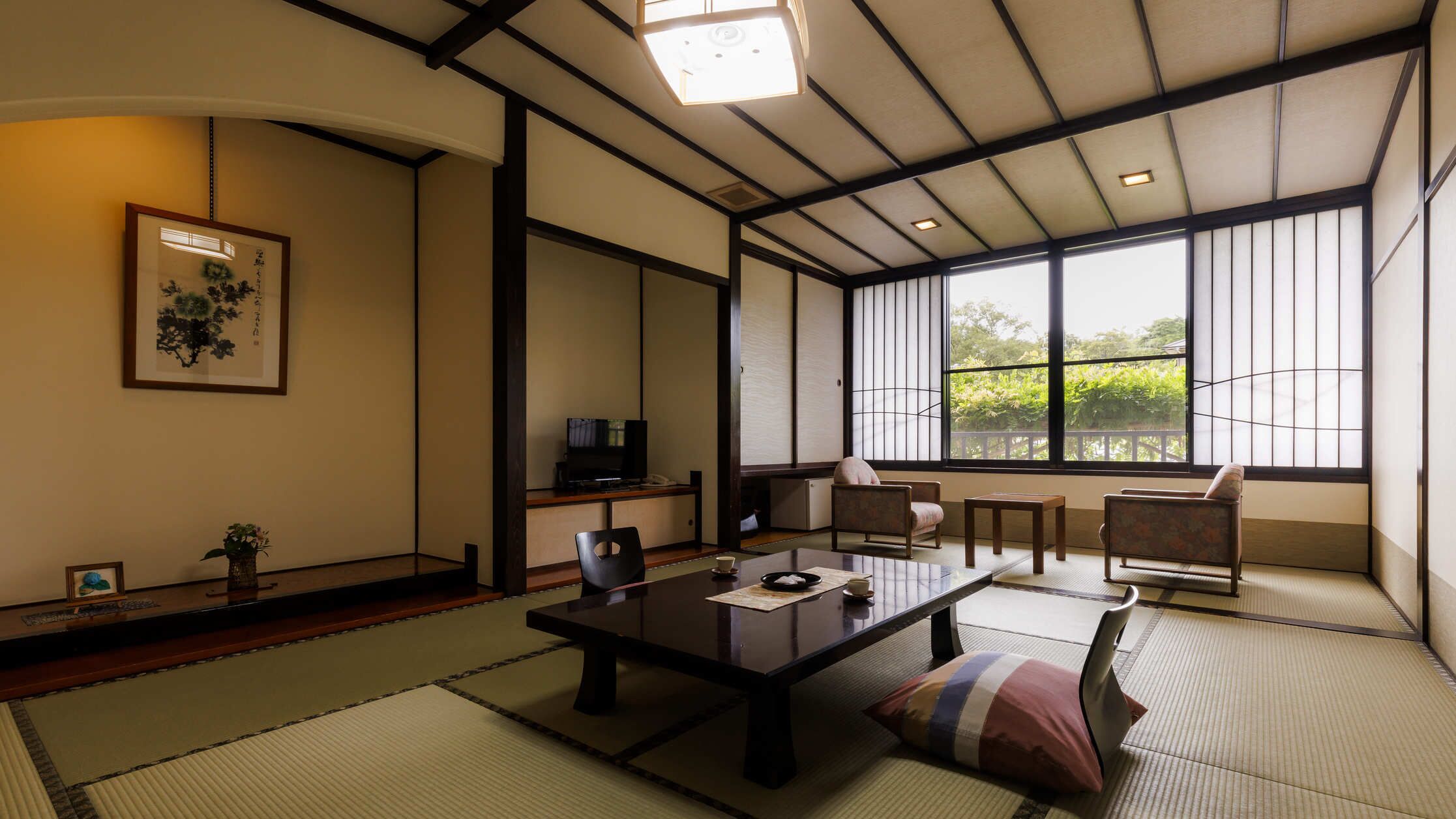 A traditional Japanese-style room with tatami flooring, a low table, and sliding doors.