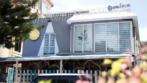 A building with a balcony and a sign that reads "Bonjour". - Favorite Bonjour Shenzhen Seaview Meisu (Shenzhen)