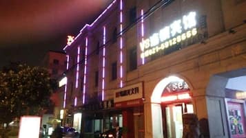 A building with illuminated signage and a storefront.