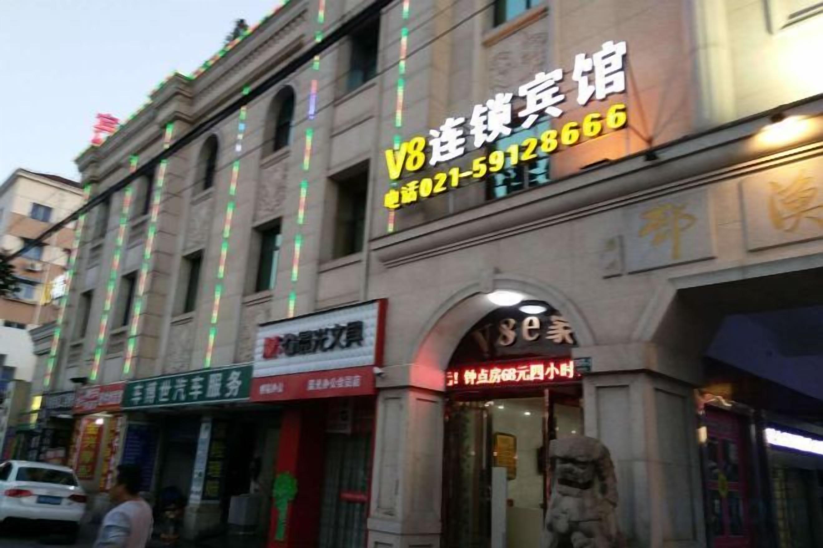 A building with multiple storefronts, including a restaurant and a shop with a red sign.