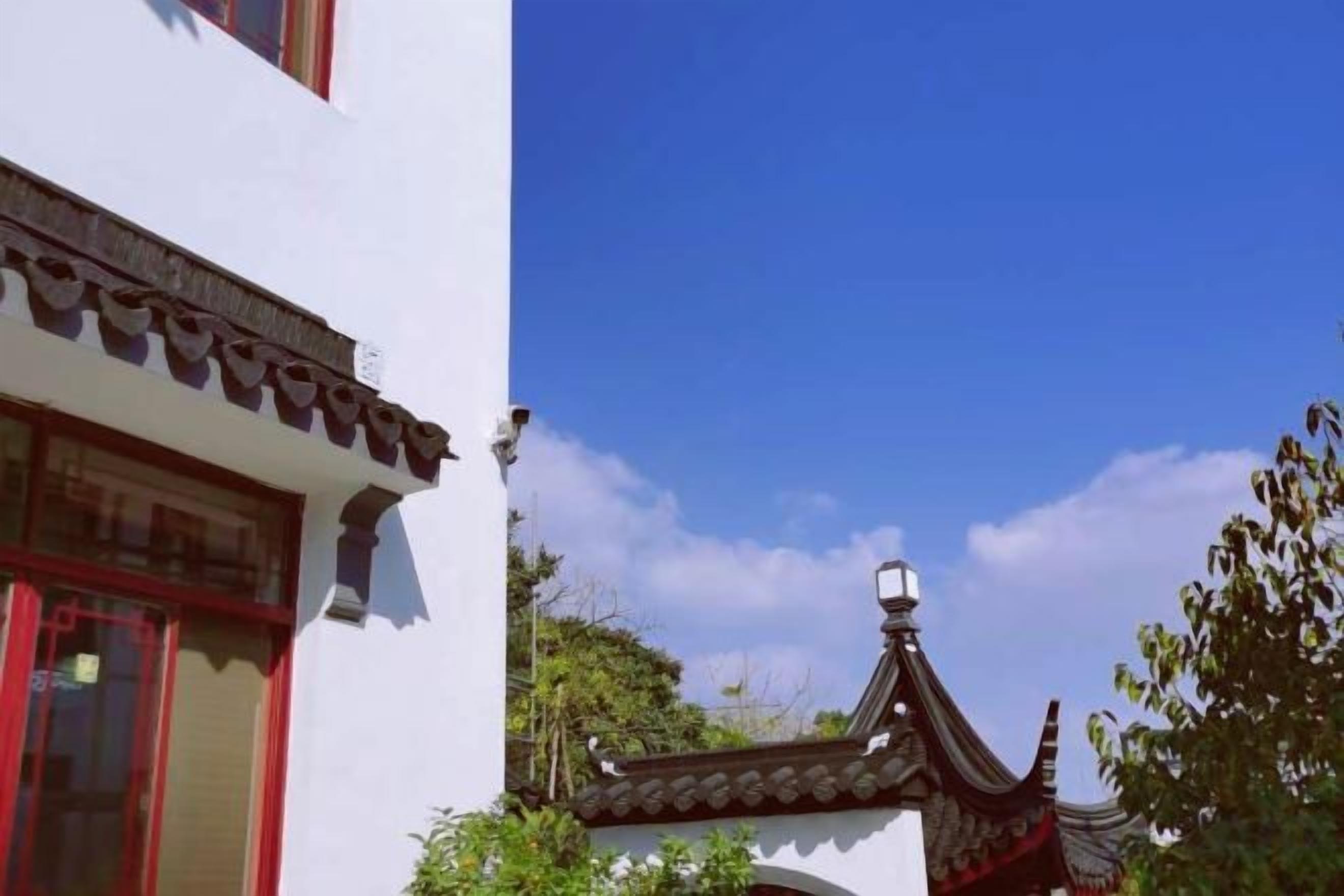 A traditional building with a distinct architectural style, including a tiled roof and a decorative finial.