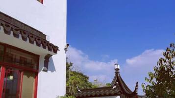A traditional building with a distinct architectural style, including a tiled roof and a decorative finial.