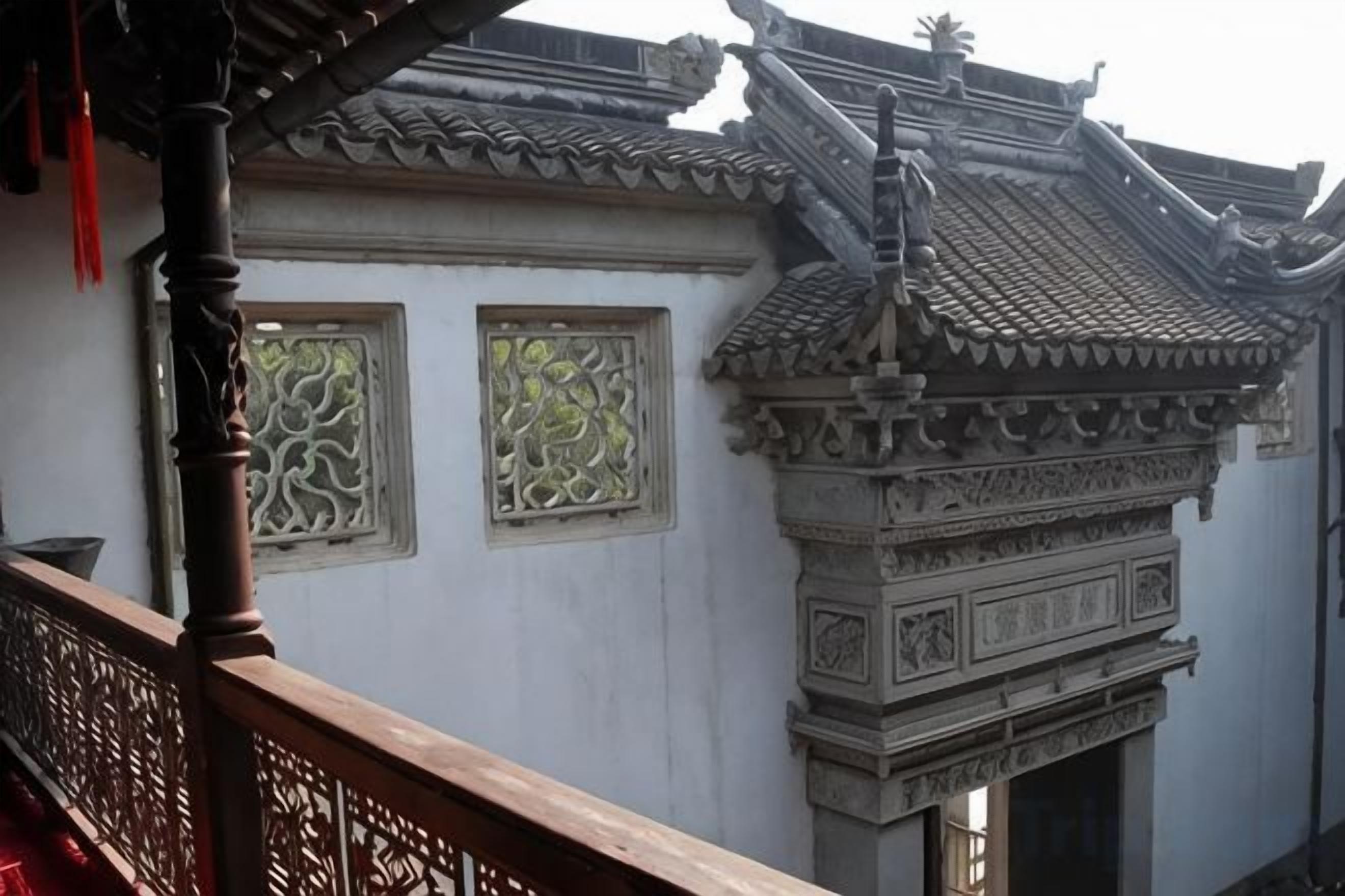 A traditional building with ornate architectural details, including a tiled roof and decorative window frames.