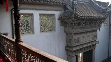 A traditional building with ornate architectural details, including a tiled roof and decorative window frames.