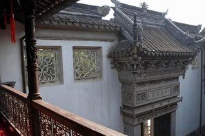 A traditional building with ornate architectural details, including a tiled roof and decorative window frames. - Jiusu Shanshuijian Guesthouse (Suzhou)