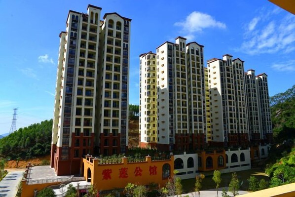 A row of high-rise residential buildings with balconies, a central courtyard, and a clear sky. - Zilian Forest Resort (Chaozhou)