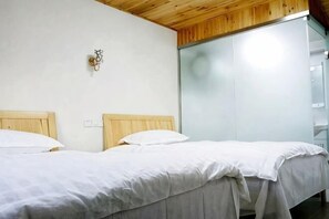 A room with two wooden beds, a wall-mounted light fixture, and a sliding glass door. - Tiankeyu Inn, Luxian County (Jing County)