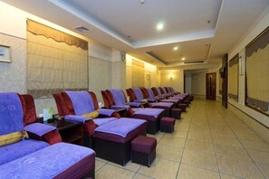 A row of individual massage chairs with footrests, arranged in a linear fashion along a wall with a tiled floor. - Dong Chang Hotel (Dongguan Hengli China Resources Shopping Plaza) (Dongguan)
