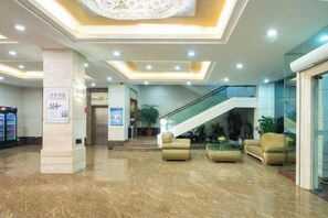 A hotel lobby with a marble floor, a staircase, and seating areas. - Dong Chang Hotel (Dongguan Hengli China Resources Shopping Plaza) (Dongguan)