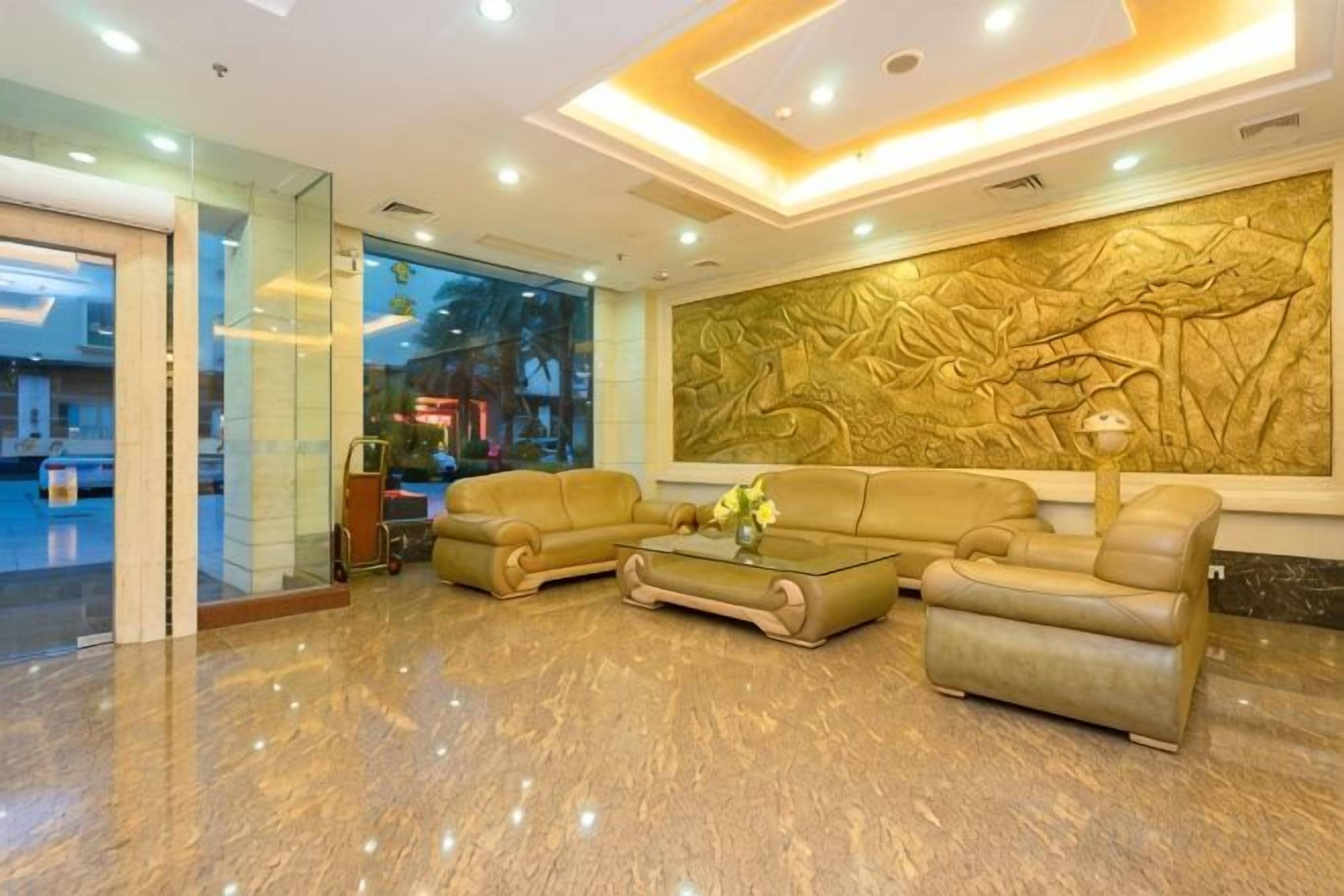 A lobby with a reception desk, seating area, and a large wall mural.
