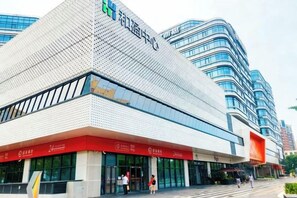 A modern building with a distinctive geometric facade, large windows, and a prominent entrance. - Days Inn Chain Hotel (Beijing Shangdi Xixiaokou Subway Station) (Beijing)