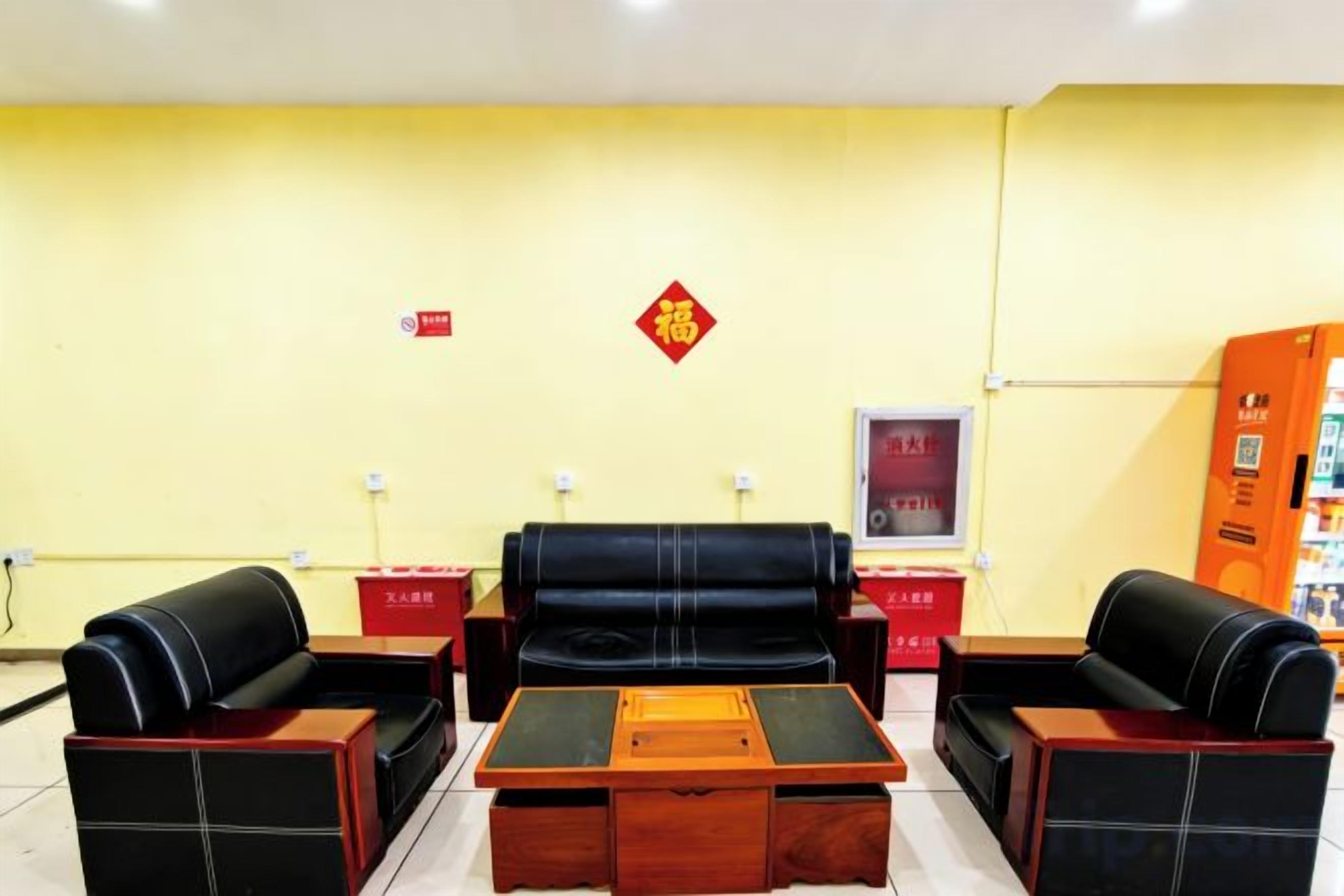 Una habitación con un conjunto de sofá, una mesa de centro de madera y un armario rojo.