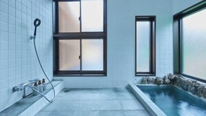 A bathroom with a bathtub, a shower, and a window. - VOYAN RESORT Izu MADOKA (Ito)