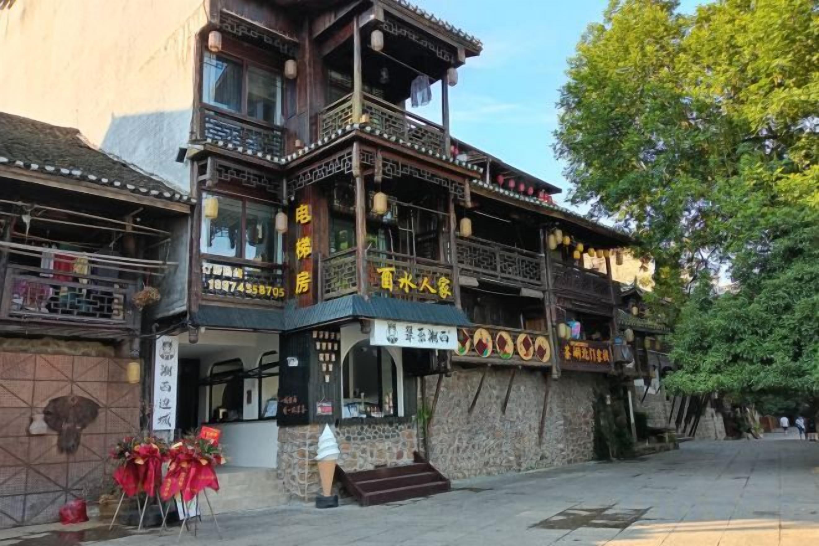 A traditional building with multiple levels, balconies, and signage indicating a restaurant.
