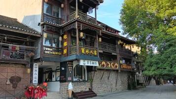 A traditional building with multiple levels, balconies, and signage indicating a restaurant.