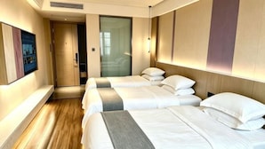 A hotel room with two beds, a wooden floor, a sliding door, and a wall-mounted light fixture. - Lavande Hotel (Chaozhou Fortune Center) (Chaozhou)