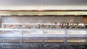 A modern bar area with a stone wall backdrop and a marble countertop. - Lavande Hotel (Chaozhou Fortune Center) (Chaozhou)