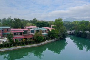 A riverside residential area with houses along the water's edge.