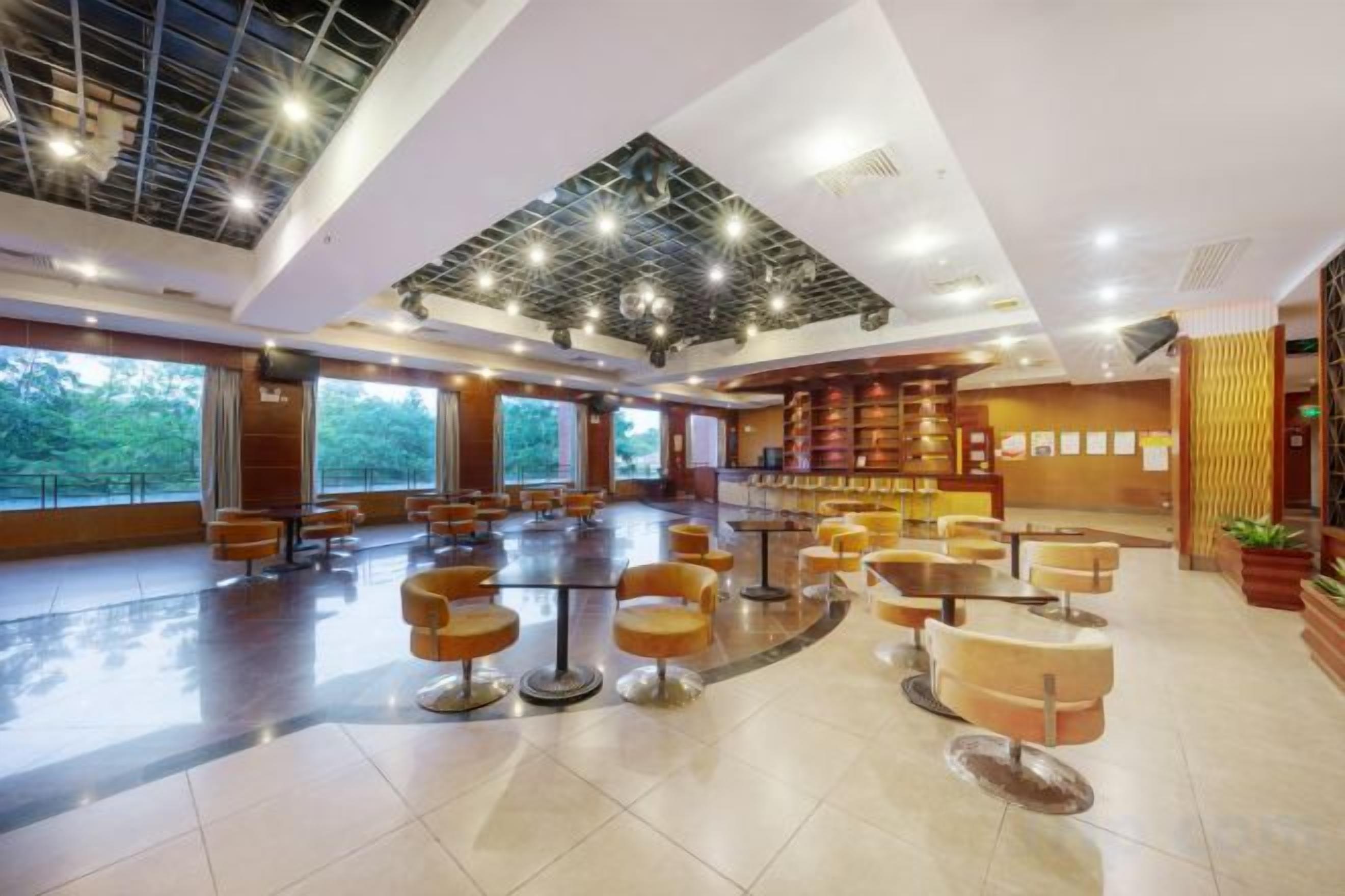 A spacious lobby with high ceilings, multiple seating areas, and a reception desk.