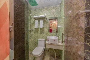A bathroom with a toilet, sink, and mirror. - Shenli Hostel (Shanghai)