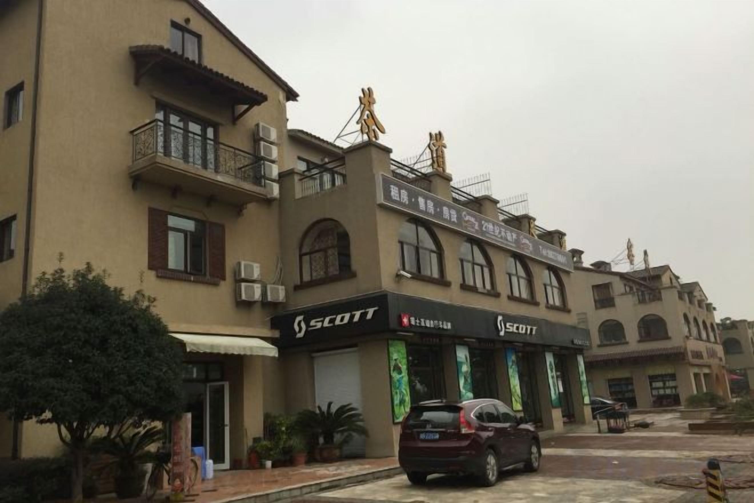 A building with multiple storefronts, including a Scott store.