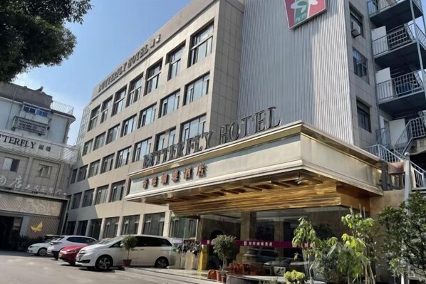 A hotel with a modern facade, multiple floors, and a prominent entrance.