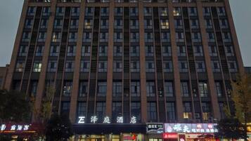 A multi-story hotel with a prominent signage at the ground level.