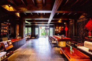 A traditional interior with a bar area, seating, and a view through the doorway. - Sante Langkou Club (Chongyang)